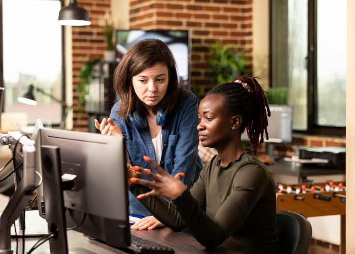 two women working on a computer